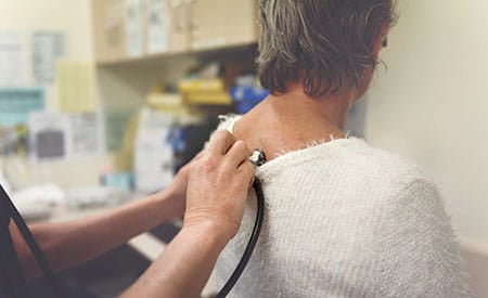 preventive-care-doctor-listening-to-womans-lungs-with-stethoscopejpg-1