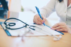 doctor-writing-on-clipboard