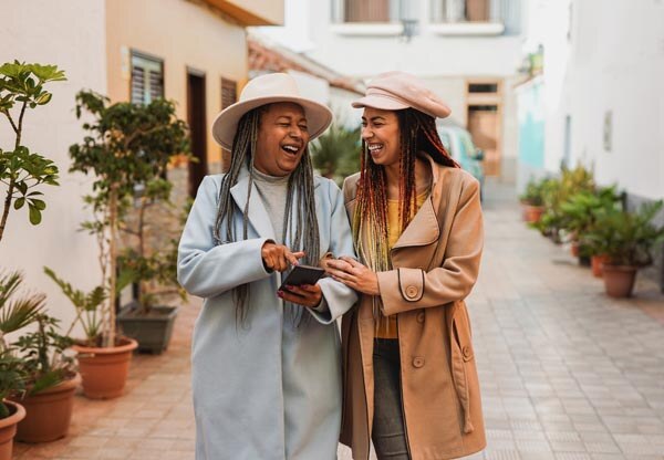 happy-african-mother-and-daughter-having-fun-together-using-mobile