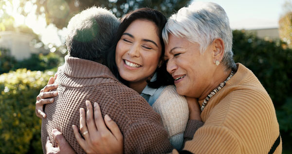 mexican-family--hug-and-smile-for-reunion--outdoors-and-love